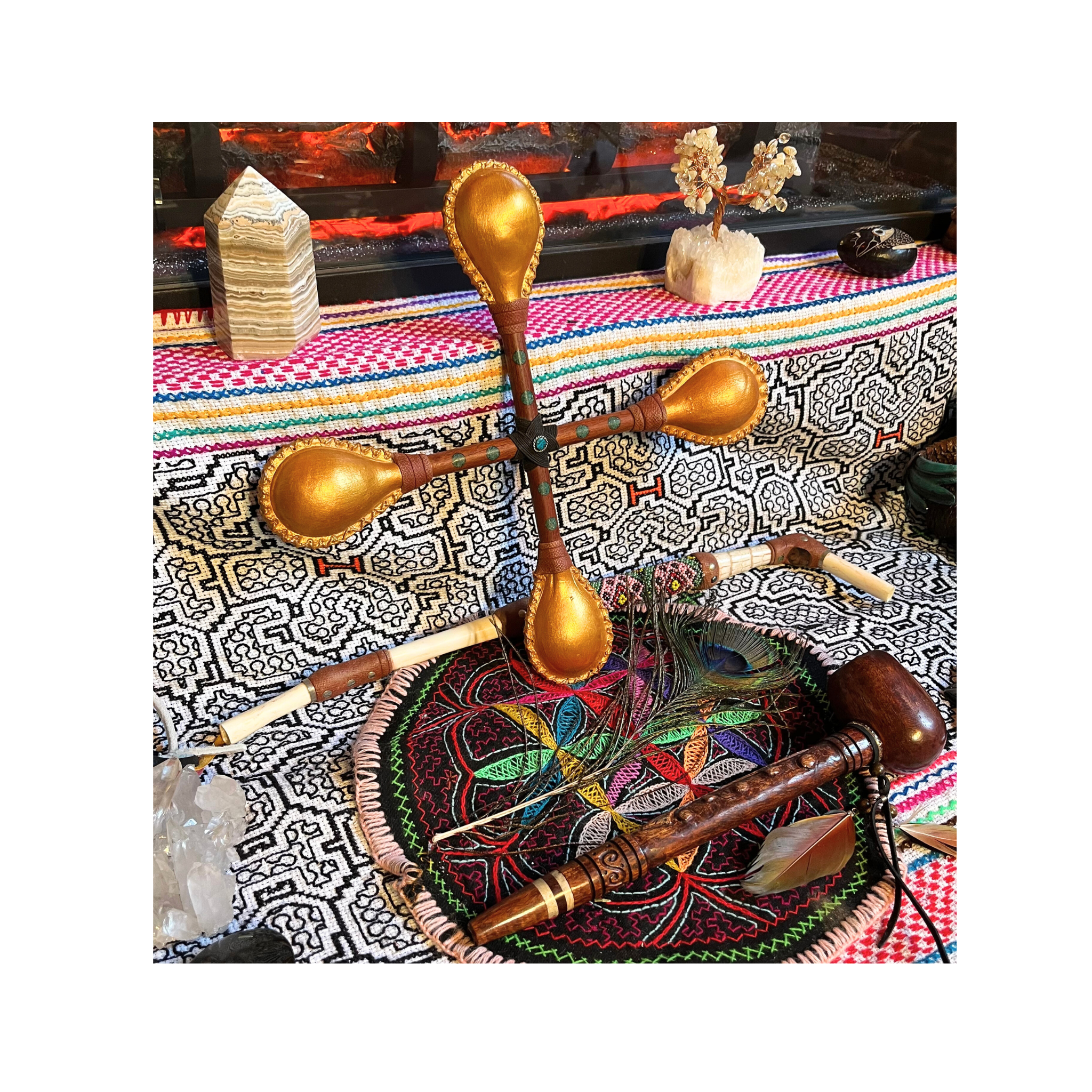 Handcrafted ceremonial sound sculpture featuring multi-directional maraca elements, sacred woods, and ritual instruments arranged on traditional Peruvian textiles.