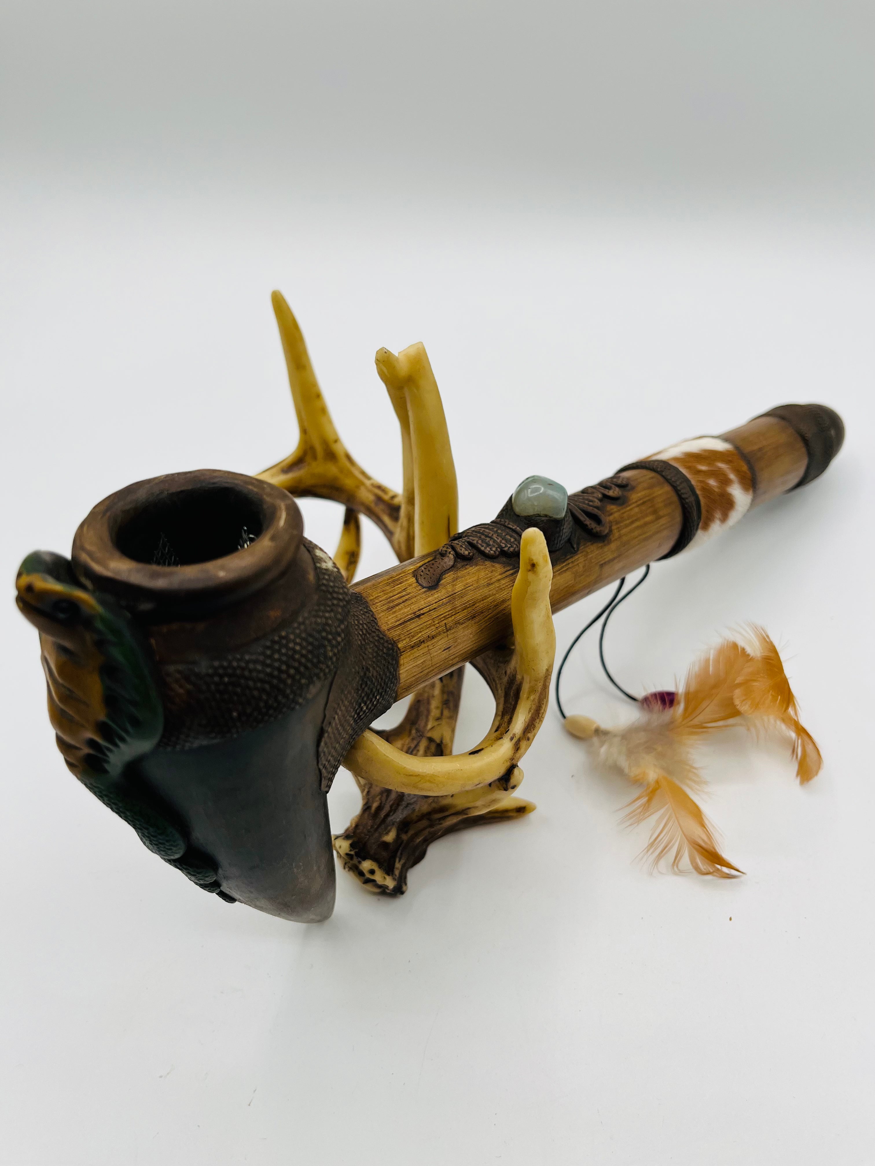 Large bamboo peace pipe with serpent carving and natural horn stand
