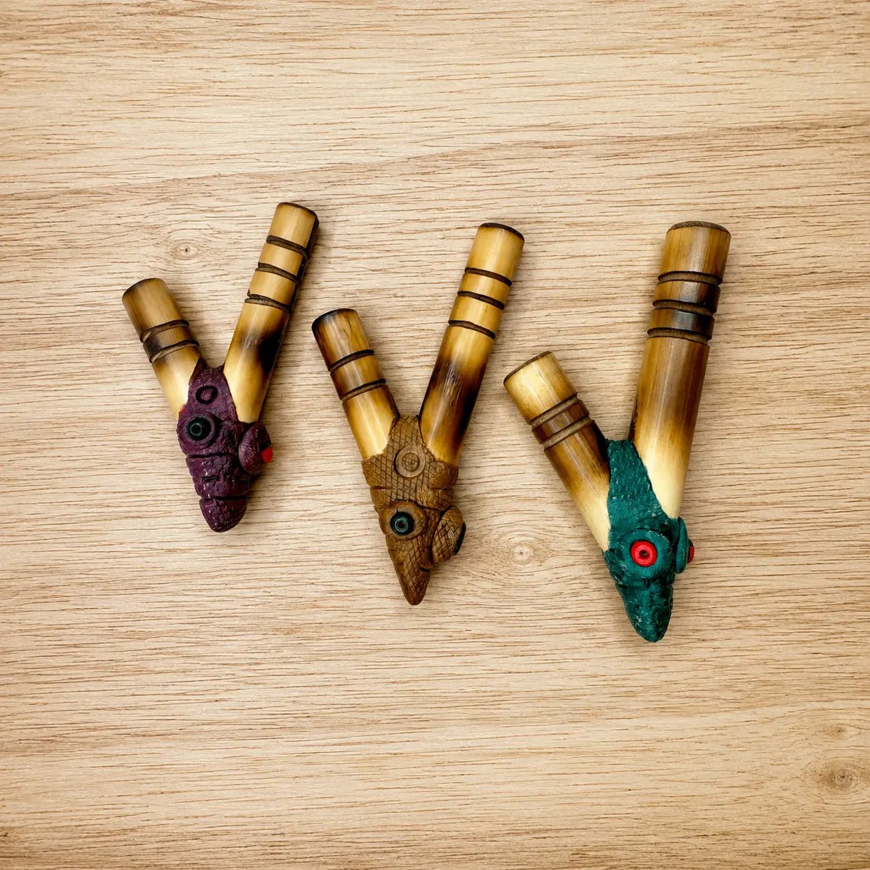 Three handcrafted Bamboo Kuripes in Small, Medium, and Large nostril gauges, displayed side by side on a light wooden tray.