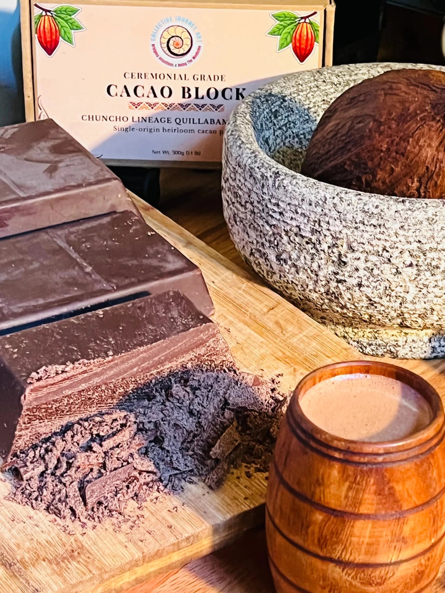 Ceremonial cacao block with freshly shaved cacao flakes, traditional wooden cacao cup, cacao pod, and stone mortar, showcasing heirloom Chuncho cacao from Peru.