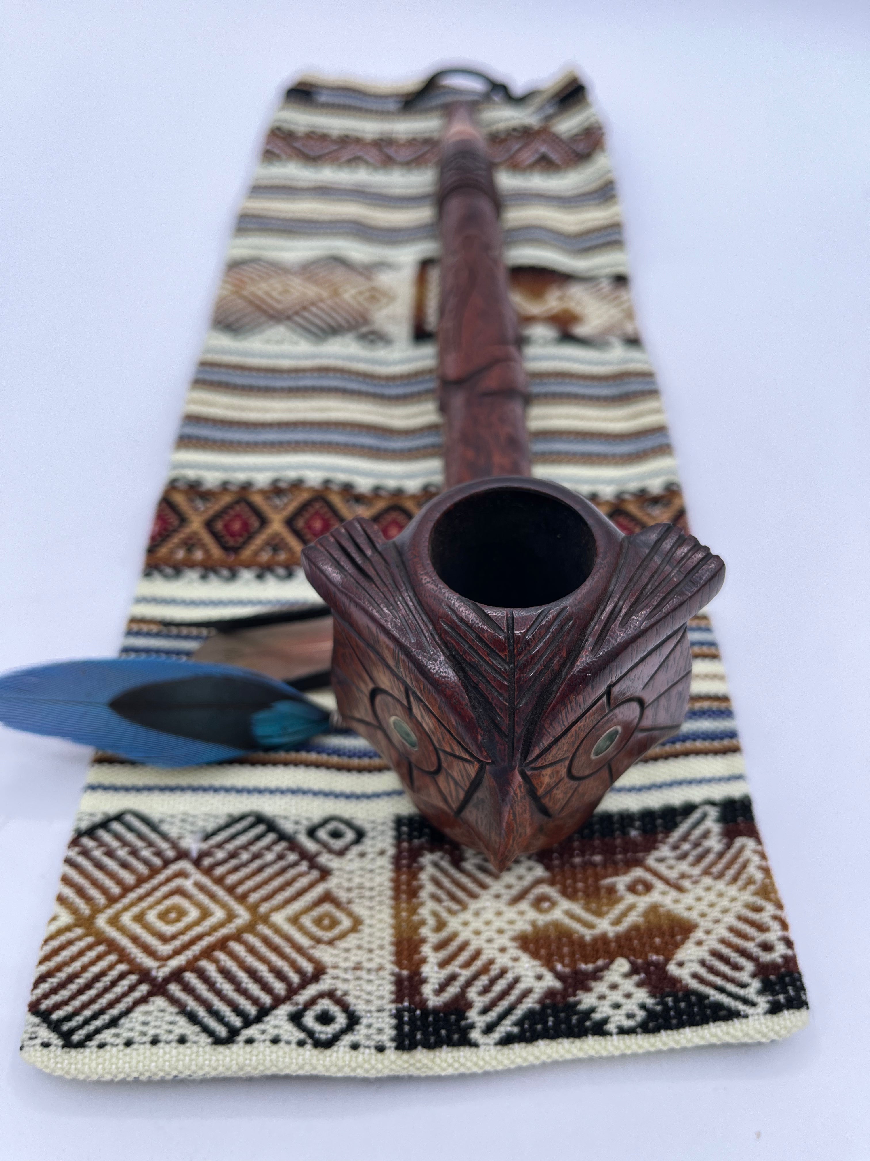 Top view of owl peace pipe with engraved jade stone eyes, handmade drawstring bag to carry safely. 