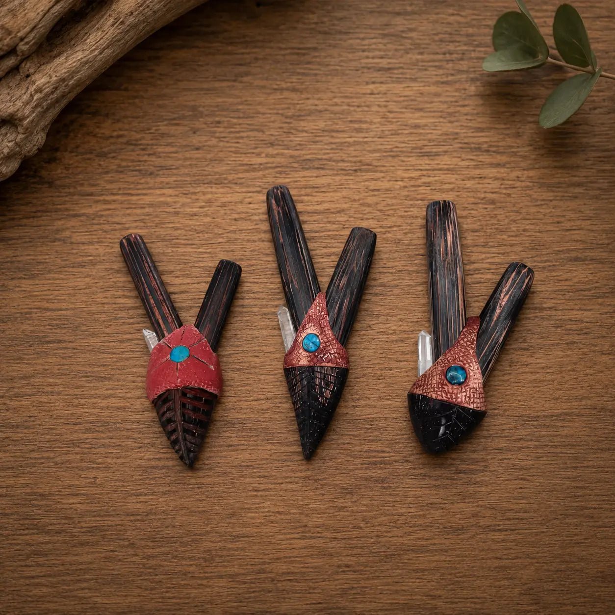 Handcrafted Wizard wooden kuripes with crystal inlay displayed on a natural wooden surface, small, medium and large nostril gauges.